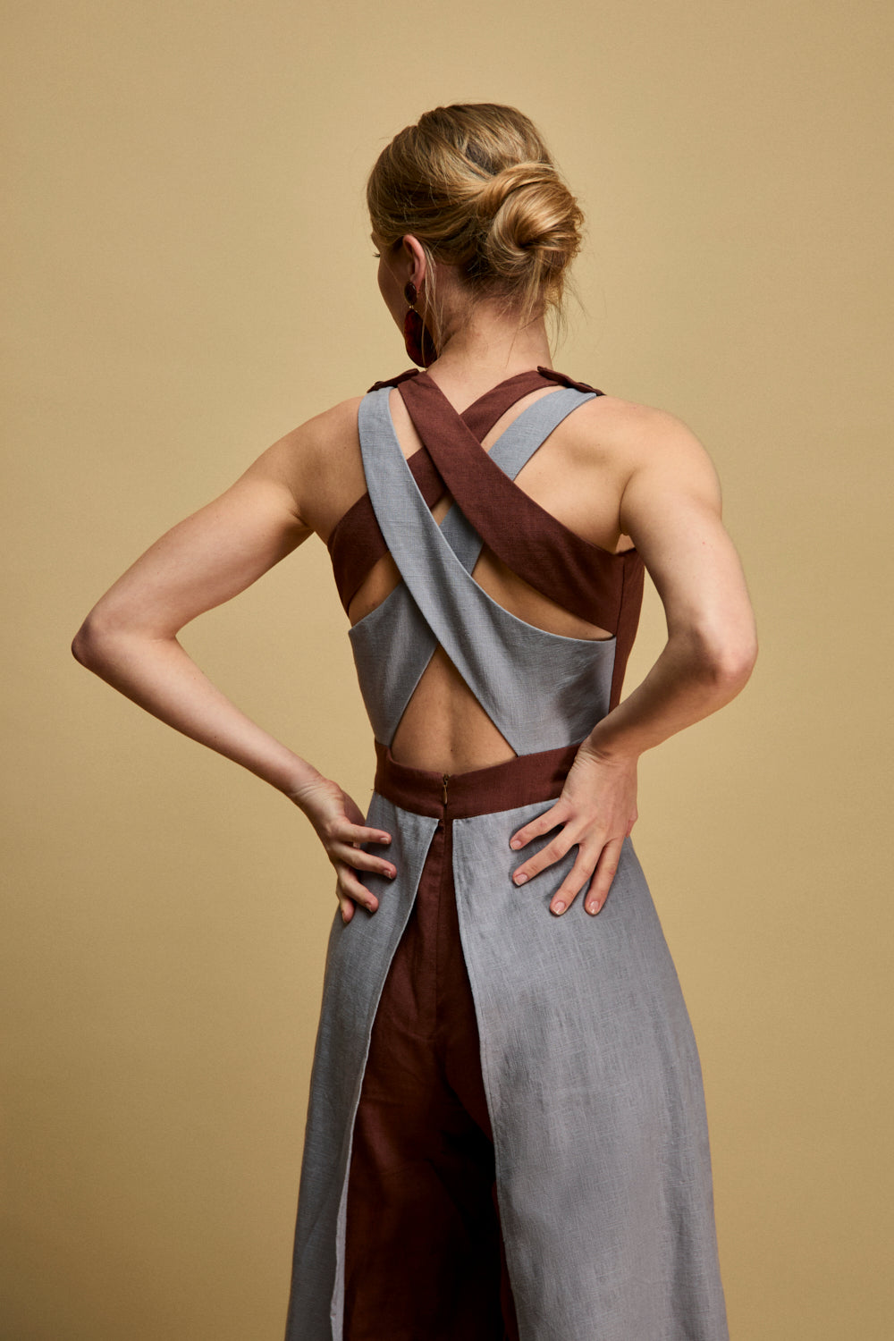 Mono de tirantes cruzados en color marrón con pieza superpuesta a contraste desde la cintura.