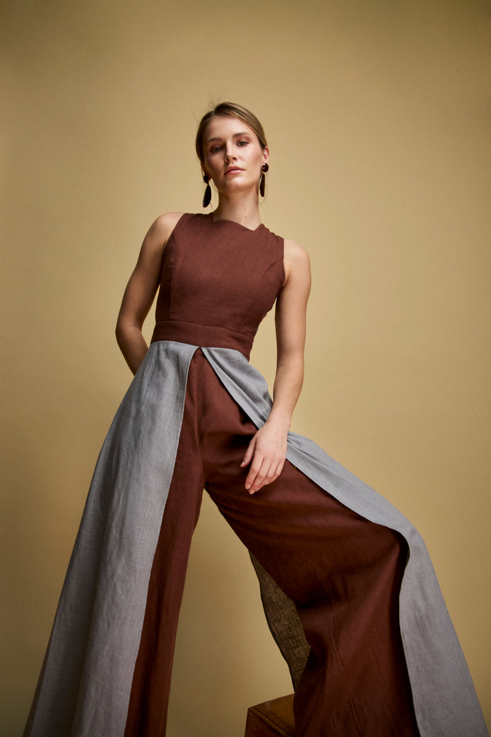 Mono de tirantes cruzados en color marrón con pieza superpuesta a contraste desde la cintura.