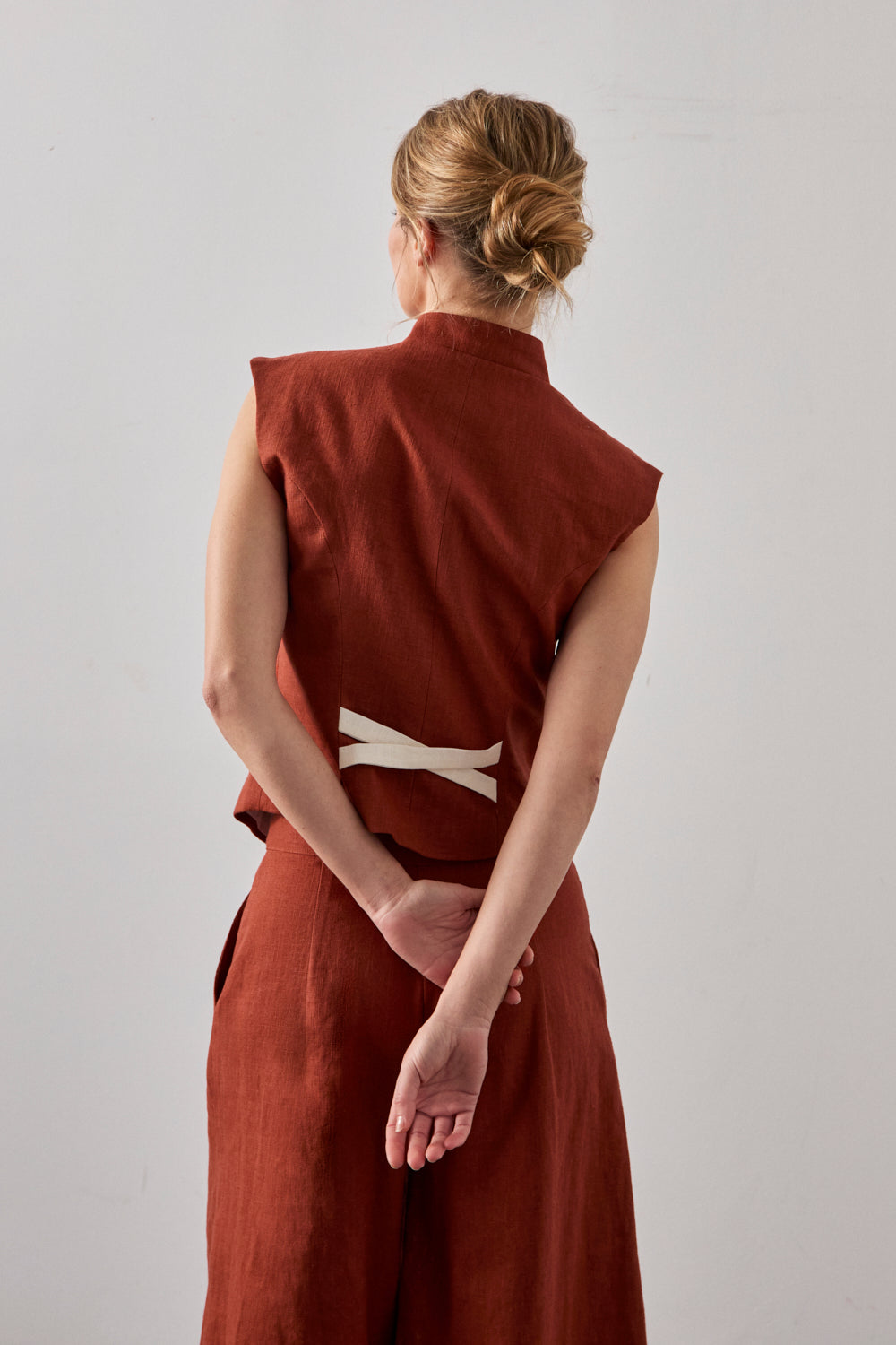 Chaleco en color caldera con cuello mao y detalle a contraste en espalda. 